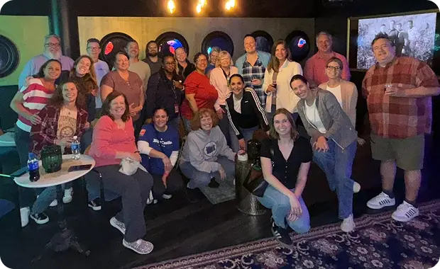 Group of White Castle employees smiling together at a team social gathering.